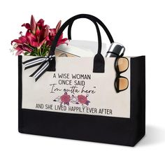 a black and white shopping bag with flowers in the bottom right hand corner that says, a wise woman once said i'm not here and she lived happily ever after