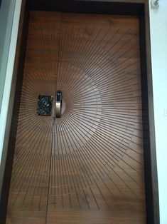 the door is made out of wood and has a cell phone in it's center