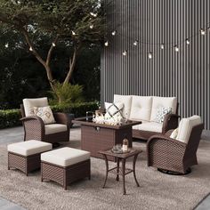 an outdoor living room with wicker furniture and lights