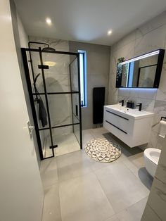 a bathroom with a shower, toilet and sink in it's center area is shown