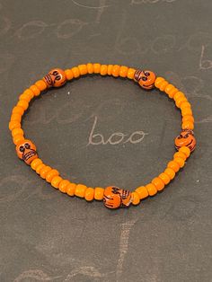 This is a skull beaded bracelet.  It would make a great addition to your Halloween costume. It would make a spooky gift for a teen for Halloween. It has five orange skull beads. It has orange seed beads. It was made with .8mm sturdy stretch string. I tie it several times to prevent breakage. It fits most teens and women. It stretches to fit on the wrist. All items are ready to be shipped I do combined shipping. Items ship in 2-5 business days. Check out more items at: http://www.etsy.com/shop/Me Halloween Novelty Beaded Bracelets With Round Beads, Halloween Bracelets With Letter Beads And Round Shape, Halloween Letter Beads Bracelet With Round Beads, Halloween Novelty Bracelet With Round Beads, Novelty Beaded Bracelets For Halloween, Adjustable Beaded Stretch Bracelet For Halloween, Orange Beaded Bracelets For Halloween, Handmade Halloween Festival Bracelets, Handmade Halloween Festival Bracelet