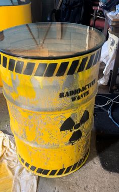 a yellow bucket sitting on top of a cement floor