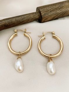 These hoops are another of my favorite earrings in my collection. A classic hoop with a statement Freshwater Pearl. Dress them up or down. Is crafted from 2mm tubing, making it lightweight and comfortable to wear. The hinged post simply clicks securely into the catch to create a fast, easy-to-use closure. These hoops are 14/20 gold filled, rose gold filled and sterling silver. • tarnish resistance• these gold hoops are made with hypoallergenic tubing for sensitive skin. Material 14K gold-filled Tarnish Resistant 14k Gold Filled Dangle Hoop Earrings, Single 14k Gold Filled Hoop Earring, Nickel Free 14k Gold Filled Hoop Earrings, Nickel-free 14k Gold Filled Hoop Jewelry, Handmade 14k Gold Hoop Earrings For Everyday, 14k Gold Filled Hoop Earrings With Pearl Drop, Small Hoop 14k Gold-filled Earrings, Everyday Metal Hoop Earrings With Pearl Drop, Handmade Adjustable 14k Gold Hoop Earrings