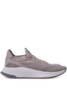 a grey sneaker with white soles