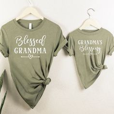 Celebrate the special bond between a new grandma and her little one with these adorable matching shirts! Our high-quality cotton tees are perfect for showing off your new grandma status in style. Whether you're a first-time grandma or adding to your collection, these matching shirts are a must-have for any proud grandmother. They also make a thoughtful gift for a new grandma in your life. Embrace the joy of grandmotherhood with these charming and comfy shirts! -EACH SHIRT IS SOLD SEPARATELY- Ple Casual T-shirt For Mother's Day Family Gatherings, Cotton Top For Family Gatherings On Mother's Day, Cotton Tops For Family Gatherings On Mother's Day, Matching Letter Print Tops For Family Events, Mother's Day Graphic Print Top For Family Reunion, Family Matching Tops With Letter Print For Gatherings, Mother's Day Family Reunion Graphic Print Tops, Green Family Matching Tops For Gift, Family Matching Green Tops For Spring