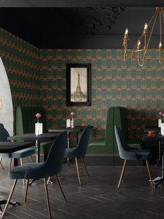 a dining room with green chairs and a black table