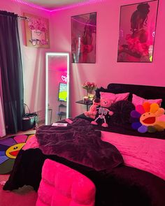 a bedroom decorated in pink and black with teddy bears on the bed, rugs and other decorations