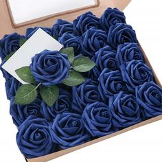 a box filled with blue roses sitting on top of a table