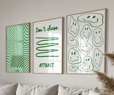 three green and white posters hanging on the wall above a couch in a living room