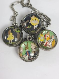 four key chains with cartoon characters on them