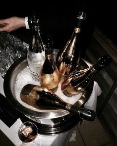 several bottles of champagne are sitting in an ice bucket