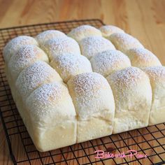 a loaf of bread sitting on top of a cooling rack with powdered sugar sprinkled on it