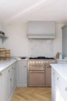 a kitchen with an oven, stove and counter tops in white painted wood flooring