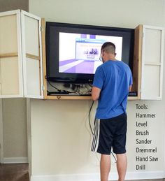 a man standing in front of a flat screen tv