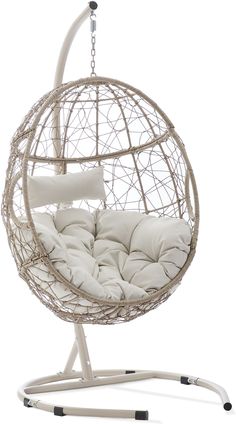 a white hanging chair with pillows on it