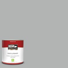 a can of paint sitting on top of a white floor