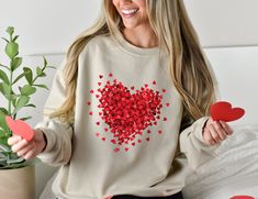 "Enjoy our \"Red Confetti Heart\" ultra cozy premium unisex sweatshirt printed with vibrant, eco-friendly inks. 🎁 This festive design makes such a unique gift for your Valentine, or for yourself to wear this Valentine's season! ❤️ The soft fleece inside also makes this crewneck a perfect matching family holiday pajama top, so prepare for Valentine's Day morning with PJs for everyone in all the different colors we offer! ❤️ RISK-FREE SHOPPING At Pith & Vinegar, we are here for YOU:). If you are Valentine's Day Cotton Sweatshirt Gift, Valentine's Day Gift Cotton Sweatshirt, Valentine's Day Sweatshirt With Relaxed Fit And Crew Neck, Valentine's Day Crew Neck Sweatshirt With Relaxed Fit, Casual Heart Graphic Sweatshirt Gift, Heart Graphic Long Sleeve Top As Gift, Long Sleeve Tops With Heart Graphic For Gift, Long Sleeve Tops With Heart Graphic As Gift, Valentine's Day Gift Sweatshirt