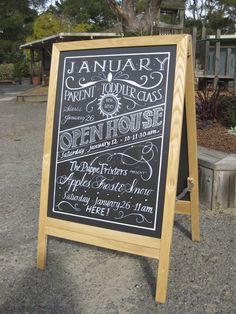 a chalkboard sign advertising an open house