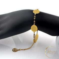 Discover elegance and faith with our exquisite Gold Allah Bracelet. This stunning piece features a delicate stainless steel chain adorned with shimmering gold beads, making it both stylish and durable. The centerpiece is a beautifully engraved gold oval pendant, showcasing the sacred Arabic script of Allah. Perfect for:  * Expressing your Islamic faith  * Everyday wear or special occasions  * A meaningful gift for loved ones  * Material: High-quality stainless steel with gold plating  * Bracelet Elegant Gold Hypoallergenic Rosary Bracelet, Elegant Hypoallergenic Gold Rosary Bracelet, Gold Bracelets With Oval Beads For Gift, Oval Gold Stainless Steel Jewelry, Gold Spiritual Beaded Chain Bracelet, Gold Metal Rosary Bracelet As Gift, Adjustable Gold Beaded Chain Rosary Bracelet, Gold Metal Rosary Bracelet For Gift, Adjustable Gold Beaded Rosary Bracelet