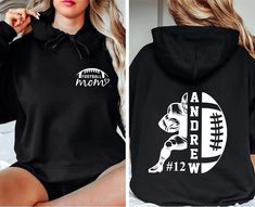 a woman wearing a black hoodie with an image of a football player on it