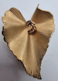 A lovely CORO signed brooch in gold leaf with design. Vintage Gold Heart Brooches, Gold Leaf Brooch For Gift, Gold Heart-shaped Brooch For Formal Occasions, Gold Heart Brooch For Formal Occasions, Gold Wedding Brooches, Gold Heart Brooch For Formal Wear, Unique Gold Wedding Brooches, Gold Costume Jewelry Brooch For Anniversary, Gold Heart Brooches For Wedding