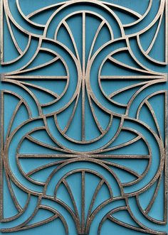 an intricate metal design on the side of a blue door, with lines and curves