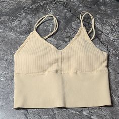 Seamless Ribbed Double Strap Tank Top. Can Also Be Worn As A Bralette. Removable Pads Double Straps 4" Band Very Stretchy Staple Piece 95% Polyester 5% Elastano One Size Fits Most (Up To A 34)- It Is Supposed To Be One Size Fits All But I Am A 36 And It Is Too Tight On Me. Color: Nude Beige Seamless Crop Tank Top, Seamless Bra For Spring, Beige Seamless V-neck Crop Top, Seamless Beige Bra For Spring, Summer Seamless Crop Top, Casual Summer Bra With Seamless Construction, Casual Seamless Summer Bra, Casual Summer Seamless Bra, Seamless Fitted Casual Bra