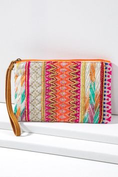 This handmade ethnic pattern clutch is the perfect accessory for modern life. Its fine cotton yarn dye with jacquard pattern adds to its unique design, while beads and leather wristlet provide a comfortable and stylish hold. Choose this practical and fashionable clutch to make any outfit pop! Shell: 100% Cotton Trim: Suede Leather Lining: 100% Polyester Measurements: L 5.25" W 8.5" Wristlet 7" Bohemian Multicolor Clutch With Zipper Pouch, Bohemian Beaded Clutch For Everyday Use, Summer Multicolor Embroidered Clutch, Multicolor Woven Pouch Clutch, Bohemian Summer Festival Clutch, Bohemian Beaded Pouch Clutch, Summer Multicolor Pouch, Handmade Multicolor Clutch For Summer, Multicolor Summer Clutch For Everyday Use