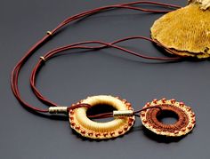 This special ethnic necklace is perfect for you and a gift for those who like to dress in boho ethnic and casual style. This jewelry combines two classic and beautiful colors - yellow-orange and light brown colores.  The necklace is handmade, crochet with S-Lon bead cord (BEAD SMITH) on a wood circle, and decorated with wine Bordo Japanese Miyuki seed beads in two rings pendant. Measurements: Total length: 36.6" (93 cm) Big pendant height and width: 2.5" (6.35 cm) Small pendant height and width: Bohemian Jewelry With Adjustable Chain, Handmade Lariat Choker Necklace For Festivals, Bohemian Necklace With Adjustable Cord For Festival, Handmade Bohemian Choker Necklace, Brown Bohemian Dangle Jewelry, Traditional Adjustable Cord Festival Jewelry, Beach Pendant Jewelry With Adjustable Chain, Long Adjustable Necklace For Festival, Adjustable Long Festival Necklace