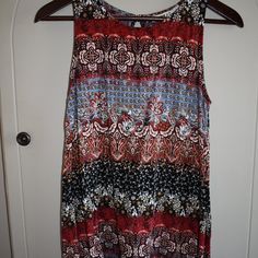 Clearance! No Additional Discounts Accepted! Gypsies & Moondust Tunic Top Size: S Material: 100% Rayon (Has Some Stretch) Color: Multicolored Shades Of Blue, Brown, Red, Black, White, Golden Tan Pattern: Paisley, Floral Sleeveless Curved Hem Peep-Hole Back Yolk W/Button Closure Scoop Neck Approx. 25 1/2" L. X 16.5" Pit To Pit Cute Top! Great For Summer! Patterned Sleeveless Printed Tank Top, Flowy Sleeveless Tops For Festivals, Bohemian Stretch Sleeveless Tank Top, Multicolor Sleeveless Boho Print Top, Multicolor Flowy Sleeveless Top, Bohemian Flowy Sleeveless Tank Top, Flowy Bohemian Sleeveless Tank Top, Sleeveless Tunic Tops, Golden Tan