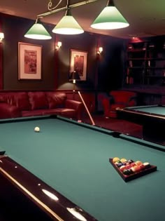 a pool table and some lights in a room