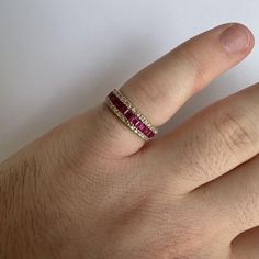 a person's hand with a ring on it