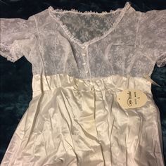 This Will Need To Be Steam Pressed But Ironing Is Not My Forte So I Will Leave It To The Lucky Purchaser. This Is An Absolutely Stunning Vintage Peignoir Still With Tags In A Size Large! It Is Very Full And I See No Damage. It Just Needs To Be Ironed. The Top Lace Is Still Crisp! I Just Can’t Resist Vintage When I See It But It Is Time For Me To Let Some Of It Go. Although It Says White On The Tag, I Would Call It Ivory. Vintage V-neck Wedding Sleepwear, Vintage White Night Dress, White Vintage Sleepwear With Delicate Lace, Vintage White Wedding Sleepwear, Vintage V-neck Wedding Nightgown, Vintage White Lace Nightgown, Vintage Lace V-neck Nightgown, White Lace Vintage Nightgown, Elegant Fitted Short Sleeve Sleepwear