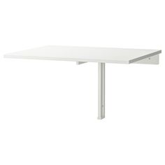 a white table sitting on top of a white floor