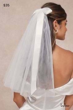 the back of a woman wearing a white veil