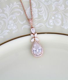 Rose gold Bridal necklace sparkles beautifully with Swarovski Pure Brilliance stones. Delicate and perfect for any bride ! Created with varied sizes of pear cut and marquise cubic zirconia stones. Necklace measures 16 inches and extends to 18 inches Pendant measures 1.5 inch x 1/2 inch Matching pieces: https://www.etsy.com/listing/497189638/rose-gold-bridal-earrings-long-wedding?ref=shop_home_active_1 https://www.etsy.com/listing/497195108/rose-gold-bridal-bracelet-crystal?ref=shop_home_active_1 Gold Pear-shaped Drop Necklace For Wedding, Rose Gold Teardrop Drop Necklace For Wedding, Wedding Rose Gold Teardrop Drop Necklace, Gold Teardrop Pendant Bridal Necklace, Rose Gold Teardrop Bridal Necklace Gift, Gold Dangle Drop Necklace For Wedding, Gold Bridal Necklace With Teardrop Pendant, Delicate Rose Gold Drop Necklace For Wedding, Rose Gold Pear-shaped Necklace For Wedding