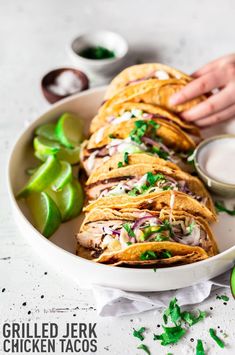 a white bowl filled with sliced chicken tacos