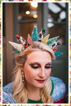 a woman with long blonde hair wearing a colorful crown