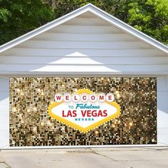 the welcome to fabulous las vegas sign in front of a white building with gold sequins