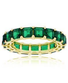 a gold ring with emerald colored stones