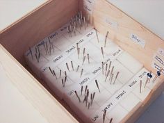 a wooden box filled with lots of needles