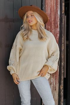 This Crochet Sleeve Pullover Sweater in Cream offers a chic blend of texture and style! Featuring long balloon sleeves with intricate crochet detailing, this sweater adds a unique flair to any outfit. It has a round neckline with ribbed detailing at the neckline, cuffs, and hem, enhancing its cozy feel. Designed with an oversized fit, it's perfect for layering and everyday comfort. Style with jeans, ankle booties, and a wide brim hat for an elevated chic outfit. Winter Knit Sweater With Lantern Sleeves, Chic Fall Knit Top With Puff Sleeves, Chic Puff Sleeve Knit Top For Fall, Knit Sweater With Balloon Sleeves For Winter, Winter Knit Sweater With Balloon Sleeves, Oversized Open Knit Crochet Top For Fall, Winter Pointelle Knit Sweater With Puff Sleeves, Oversized Pointelle Knit Sweater For Fall, Winter Textured Knit Top With Balloon Sleeves