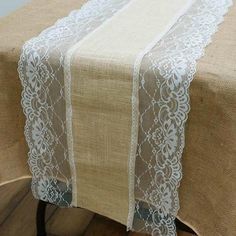 the table is covered with white lace and burlocked linens on it