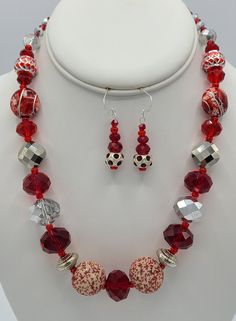 Necklace is 18 1/2 inches in length and is made with red and white specialty beads, silver crystal beads, red crystal beads, red specialty beads and red and silver specialty beads.  It has a sterling silver jump ring and a sterling silver lobster claw clasp.   Earrings are made from a red and silver round specialty bead and red crystals.  They hang a total of 1 3/4 inches in length and have a sterling silver earring wire. White Sterling Silver Jewelry With Faceted Beads, Red Faceted Round Bead Jewelry, Red Faceted Round Beads Jewelry, Red Faceted Beads Jewelry For Christmas, Red Faceted Round Beaded Jewelry, Adjustable Red Jewelry With Silver Beads, White Sterling Silver Jewelry With Colorful Beads, Red Round Beads Jewelry For Christmas, White And Colorful Beaded Sterling Silver Jewelry