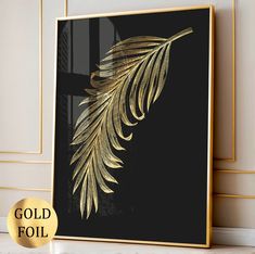 a gold foiled leaf on a black background with the words gold foil below it