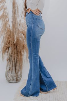 The Josie Jean RESTOCKED! The flares of flares! Turn heads in these FAB jeans! Medium Wash High Rise Super Bell Bottom Slim fit to the knee then flares below the knee No belt loops 33" Inseam 11 1/2" Rise 68% Cotton, 24%Modal, 7% Elasterell, 1% Spandex Fit is True to Size Kaylan is 5'6", wearing a 3" heel and is wearing the Size 3. Jimena (the last three pictures) is wearing the Size 5 (her true size). Cute Outfits With Bell Bottom Jeans, High Waisted Bell Bottom Jeans Outfits, Cute Bell Bottom Outfits, New Jeans Trend, Modest Jeans, High Waisted Bell Bottom Jeans, Bell Bottoms Jeans, Bell Bottom Jeans Outfit, High Wasted Jeans