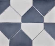 a white and gray tile wall with different shapes