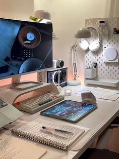 a desk with a computer monitor, keyboard and cell phone on it