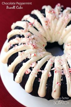 a bundt cake with white icing and sprinkles on it sitting on a plate