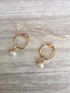 Pearl Circle Earrings. These beautiful small hoop earrings feature a single 4-5 mm freshwater pearl wire wrapped onto a gold-filled hoop. The hoop is approximately 6 mm. The hoops and French wires are gold filled. Pearl is the June birthstone. Your earrings will arrive in a gift box. If this is a gift, I would be happy to include a card with your personal message - just let me know in the message section at checkout. Small Hoop Pearl Earrings For Gift, Small Hoop Pearl Earrings As Gift For Pierced Ears, Dainty Nickel-free Round Pearl Earrings, Small Hoop Pearl Earrings Hypoallergenic Gift, Nickel-free Small Hoop Earrings For Wedding, Nickel Free Small Hoop Earrings For Weddings, Dainty Nickel-free Small Hoop Earrings, Delicate Small Hoop Earrings With Ear Wire, Delicate Hypoallergenic Small Hoop Earrings